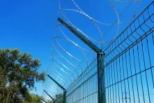 A flat barrier on a fence made of welded grid panels